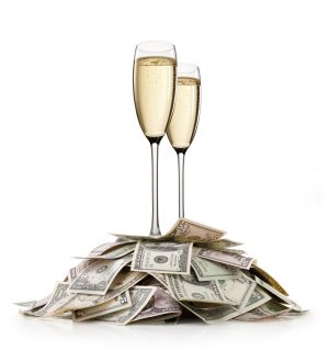 Financial success. Heap of money with Champagne